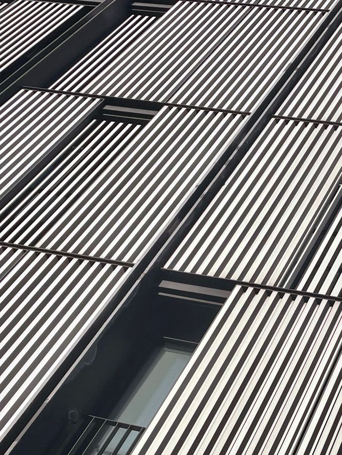 Contemporary building facade featuring striking vertical lines in Bilbao, Spain.